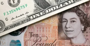 A US dollar bill partially covers a British ten-pound note-GBPUSD