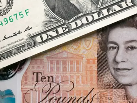 A US dollar bill partially covers a British ten-pound note-GBPUSD