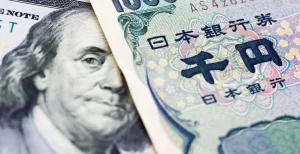 A close-up of a US dollar bill and a Japanese yen note placed side by side - USDJPY