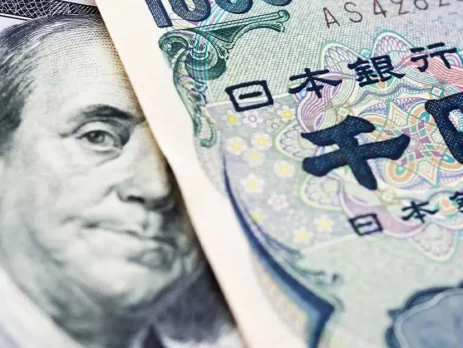 A close-up of a US dollar bill and a Japanese yen note placed side by side - USDJPY