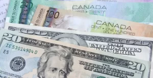 USDCAD- A close-up of Canadian and U.S. dollar bills together