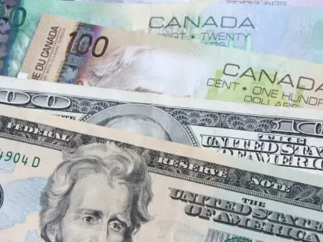 USDCAD- A close-up of Canadian and U.S. dollar bills together