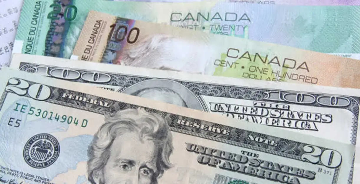 USDCAD- A close-up of Canadian and U.S. dollar bills together