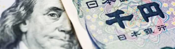 A close-up of a US dollar bill and a Japanese yen note placed side by side- usdjpy-USD/JPY-USD JPY