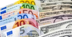 The image shows assorted Euro and U.S. dollar banknotes fanned out-EURUSD