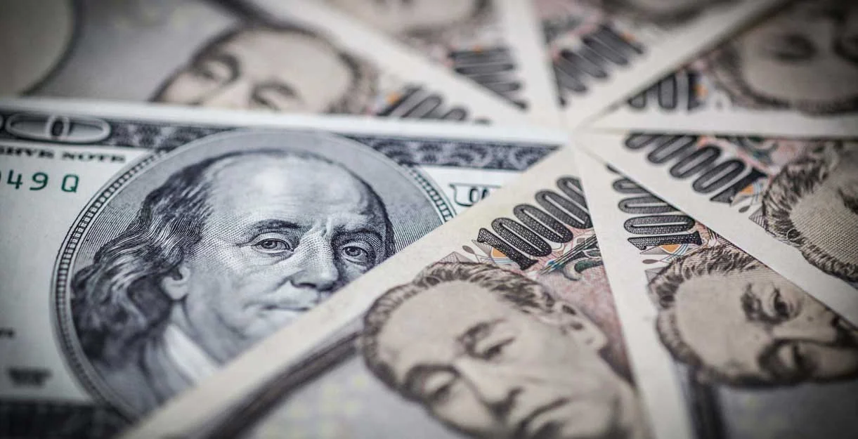 USD JPY-1D- The image shows US dollars and Japanese yen banknotes overlapping